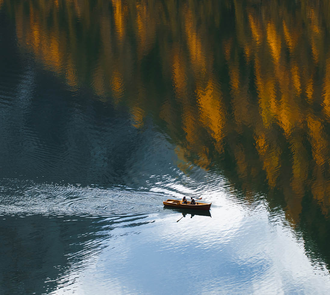 Abstract natural background with room for copy space, amazing autumn landscape with mirror reflection in clear water surface from above. Natural pattern. Fall in mountains. Drone point of view. Tourist attraction and recreational pursuit. Travel in European Alps.